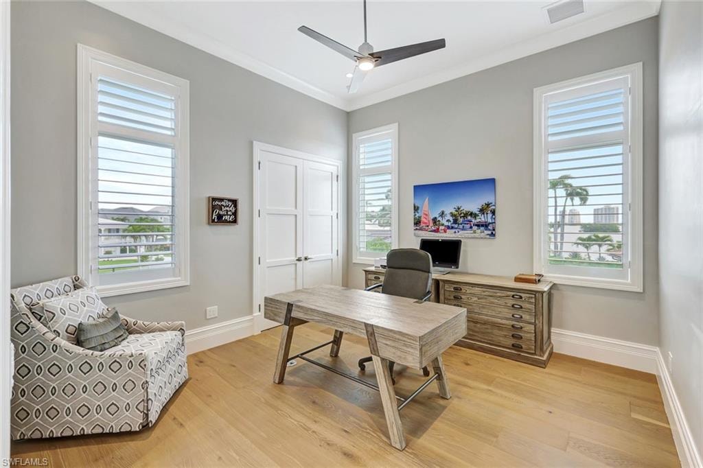 Office/ Guest Bedroom 3 Home office featuring a ceiling fan, light wood-type flooring, baseboards, and crown molding