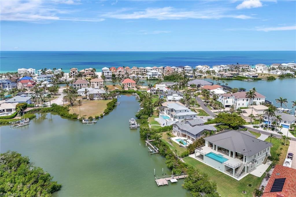 Aerial perspective of suburban area featuring a nearby body of water