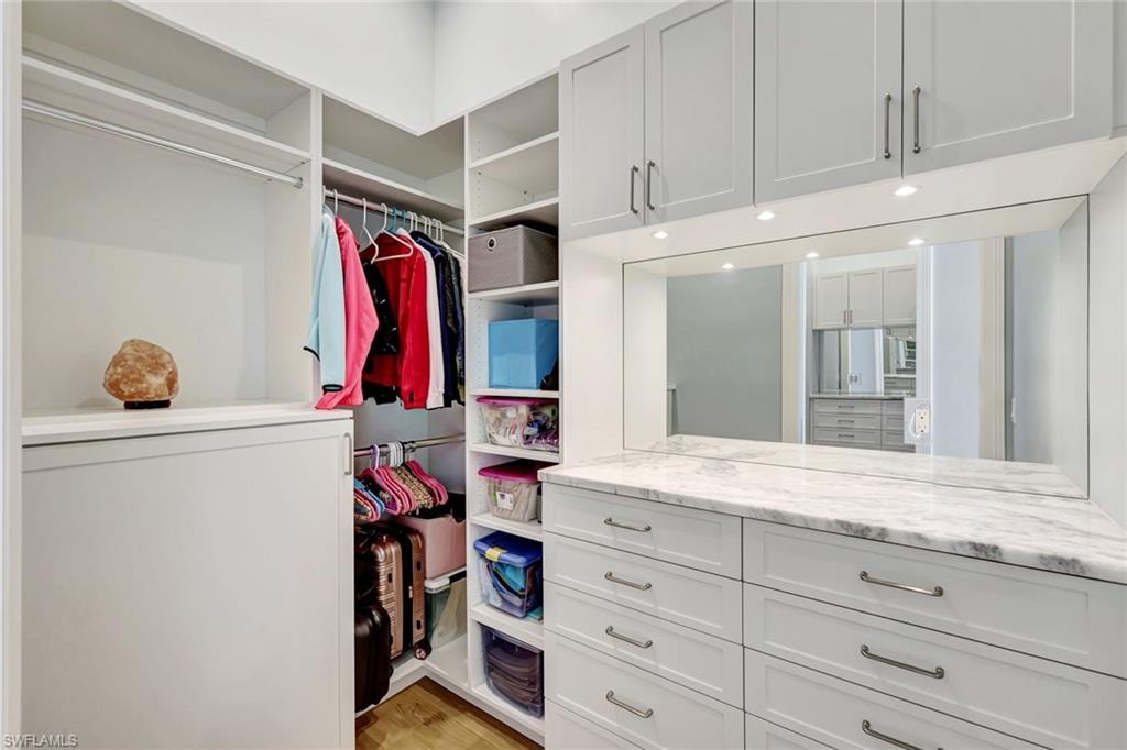 Master Spacious closet with light wood-type flooring