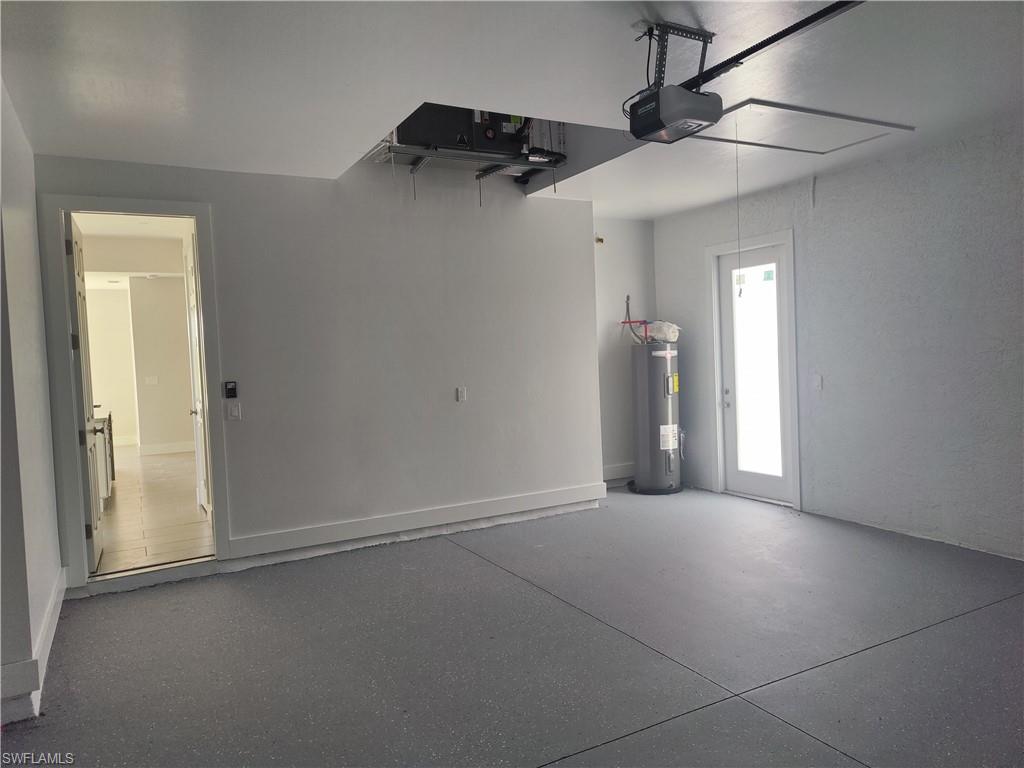 Garage with electric water heater and a garage door opener