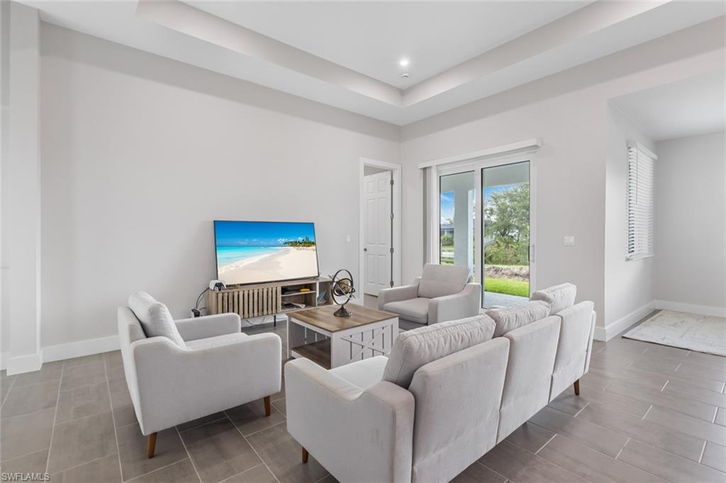 Living area with a raised ceiling and recessed lighting