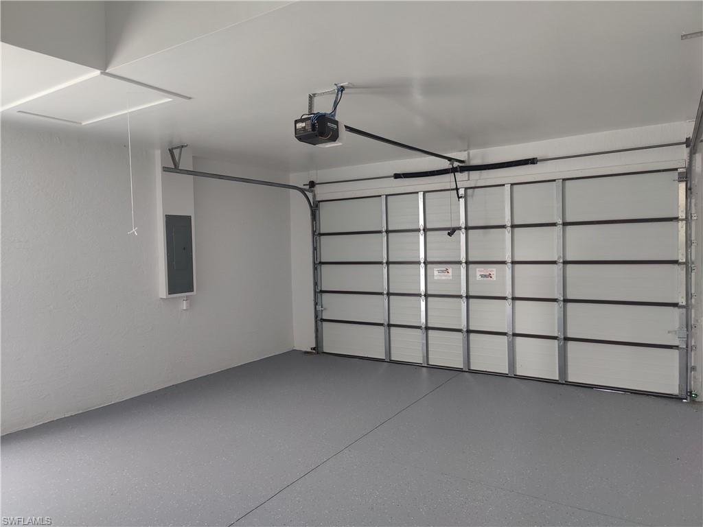 Garage with a garage door opener and electric panel