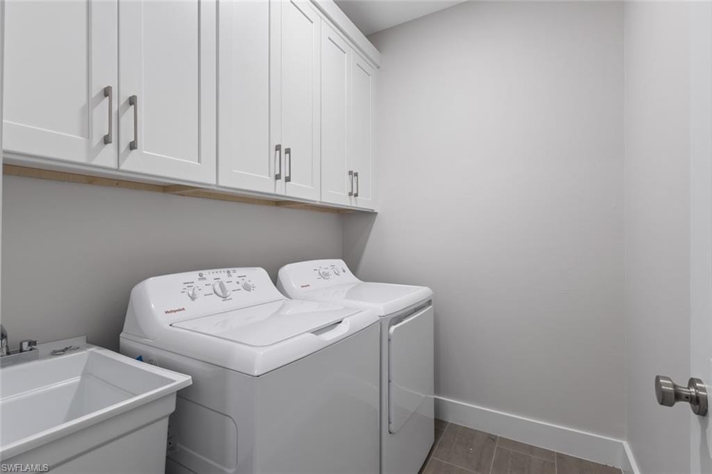 Laundry room featuring cabinet space and independent washer and dryer