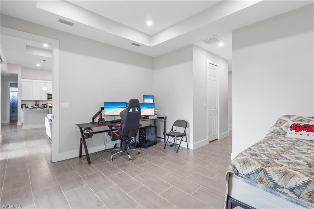 Bedroom with a desk and recessed lighting