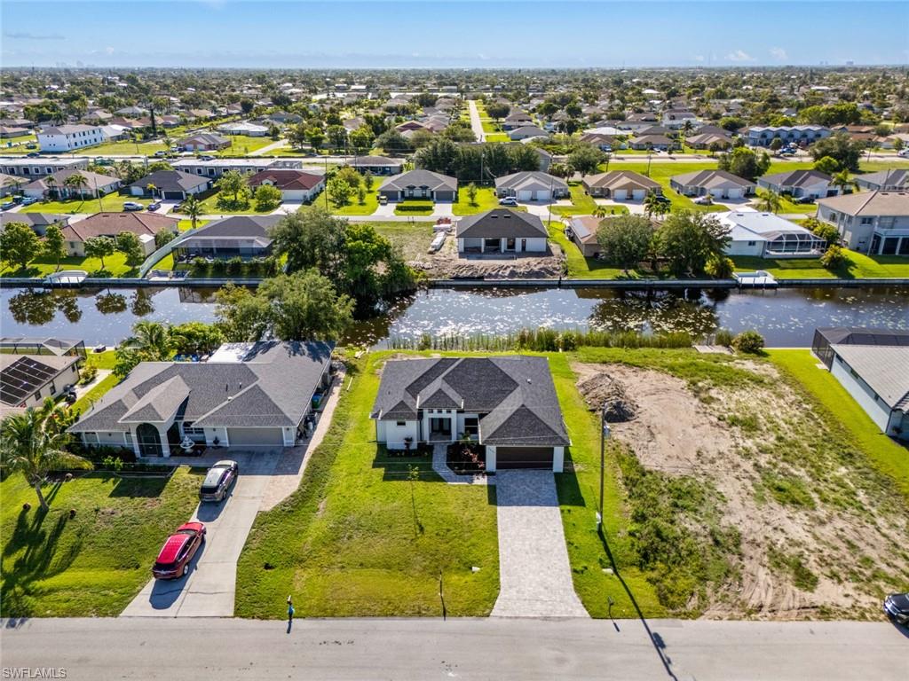 Aerial view of residential area featuring a large body of water
