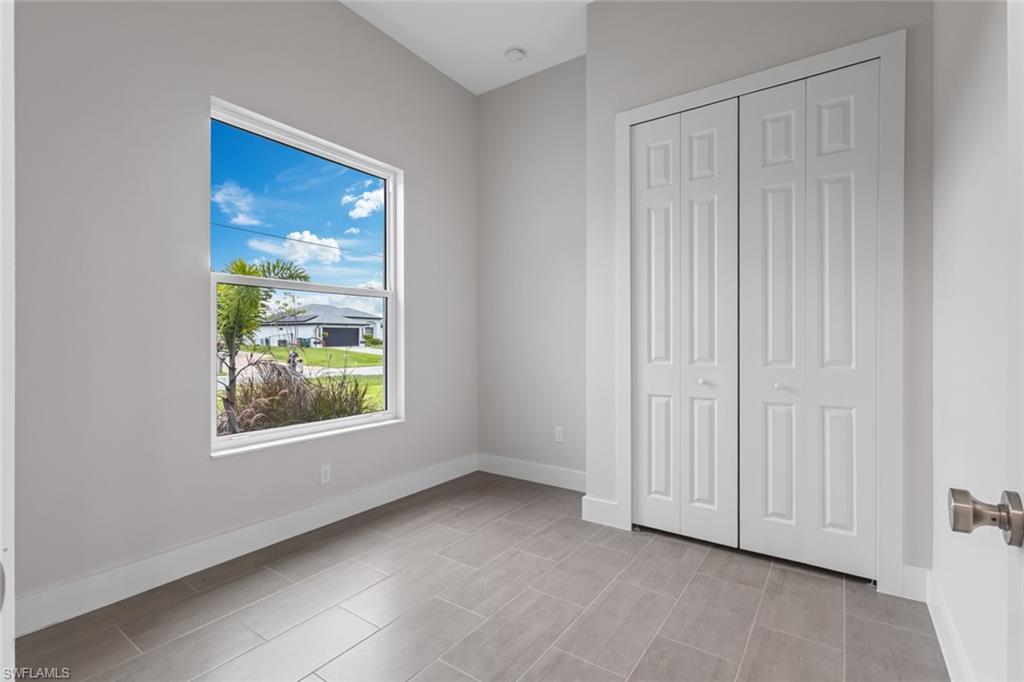 Unfurnished bedroom featuring a closet and baseboards