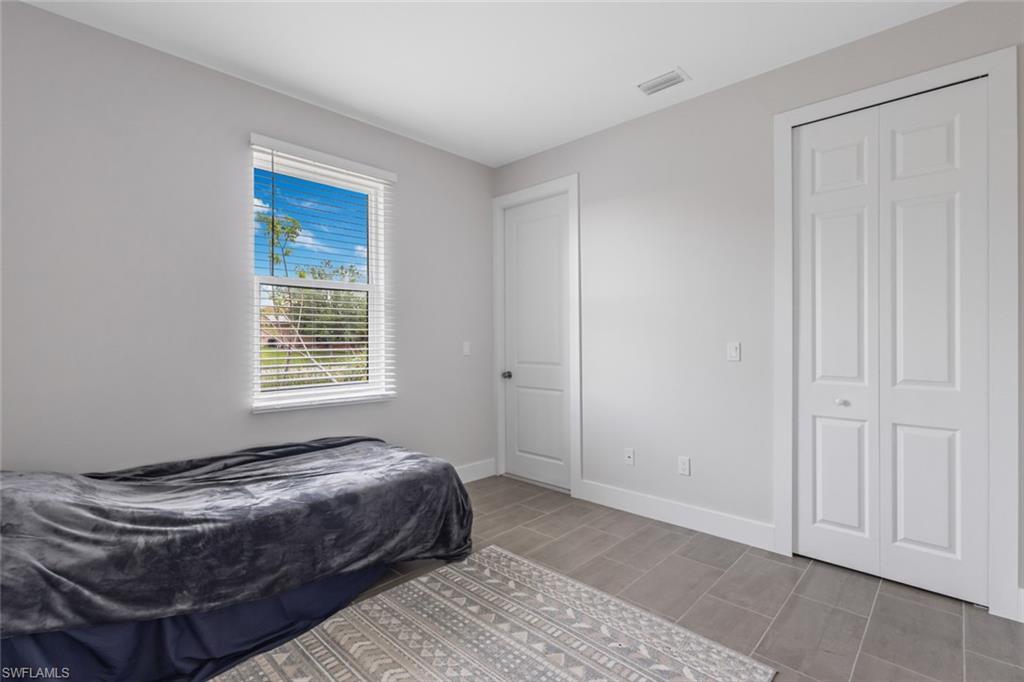 Bedroom featuring baseboards and wood finish floors