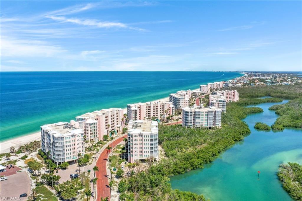 View of urban area with a nearby body of water and apartment complex / building