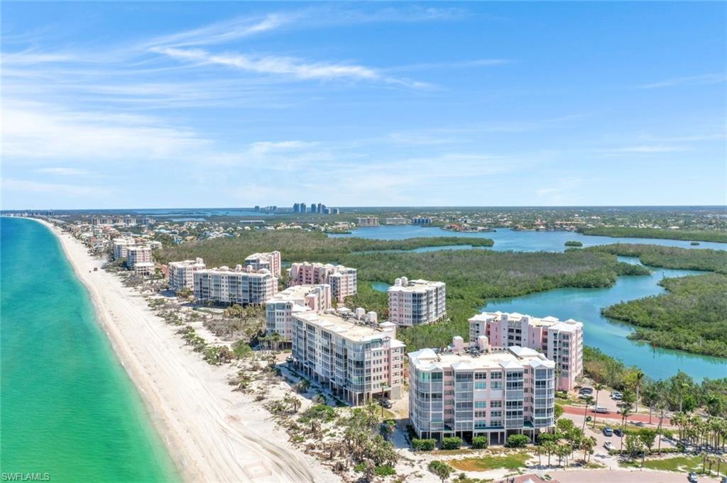 Drone / aerial view of extended coastline and apartment complex
