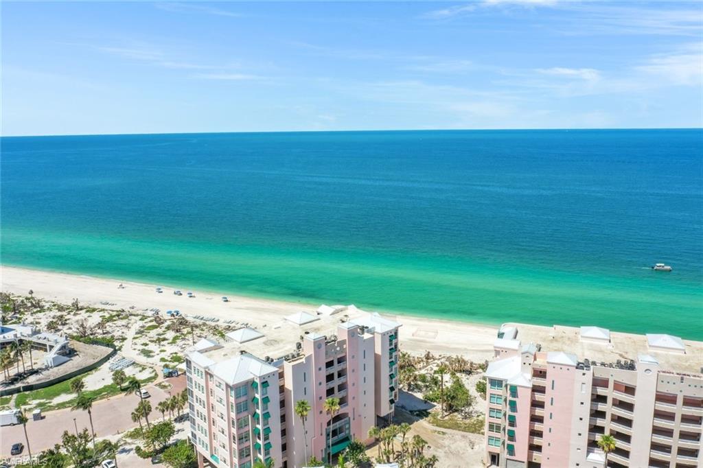 Drone / aerial view of expansive beach and apartment complex / building