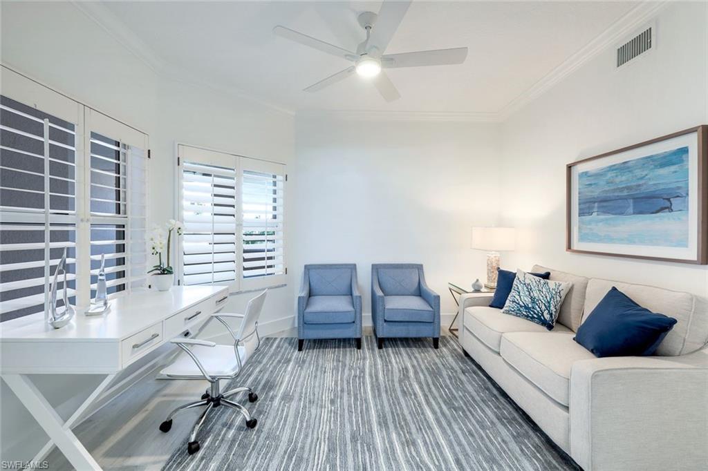Home office with ornamental molding, a ceiling fan, and baseboards