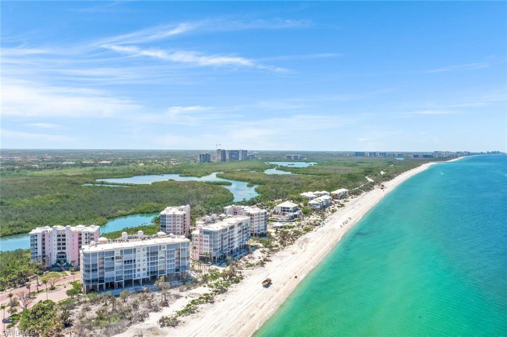 Bird's eye view of expansive coastline and apartment complex
