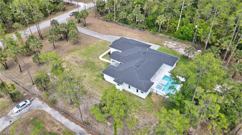 Aerial view of property and surrounding area with a pool