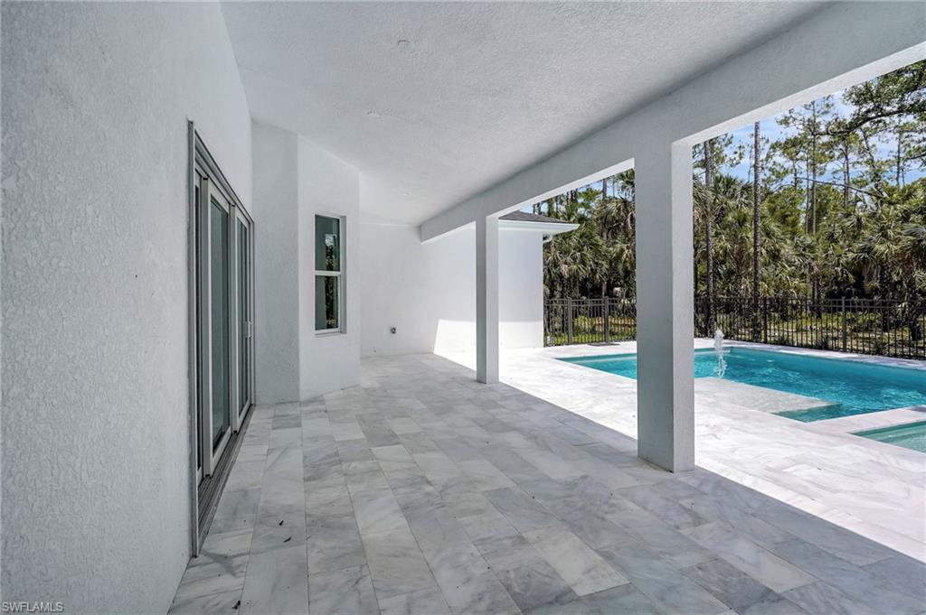 View of pool featuring a patio and fence
