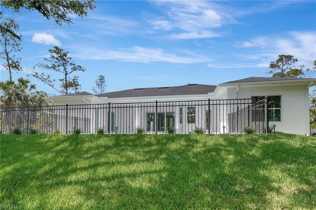 Rear view of property with stucco siding