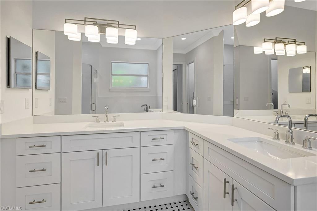 Full bath with a shower stall, vanity, and tile patterned floors