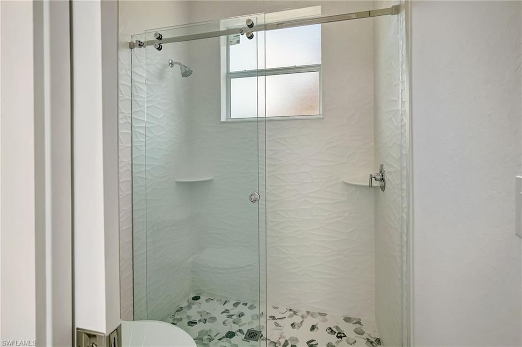 Full bath with a shower stall and toilet