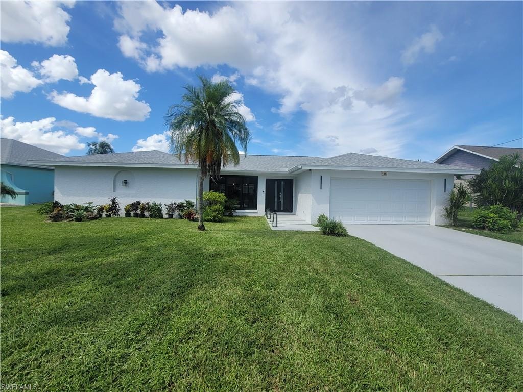 Single story home featuring driveway, an attached garage, stucco siding, and a front yard