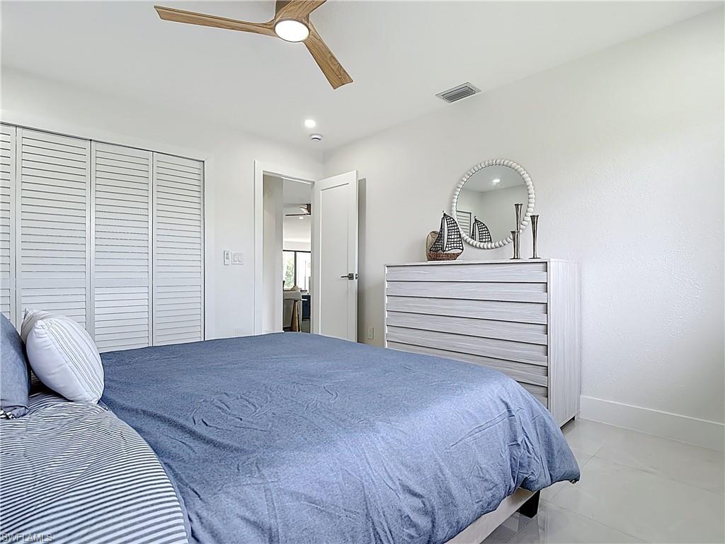 Bedroom featuring baseboards, ceiling fan, and a closet