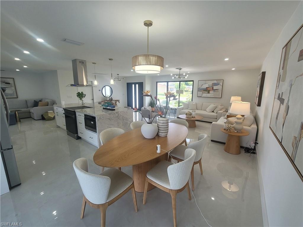 Dining room with recessed lighting, a chandelier, and light tile patterned floors