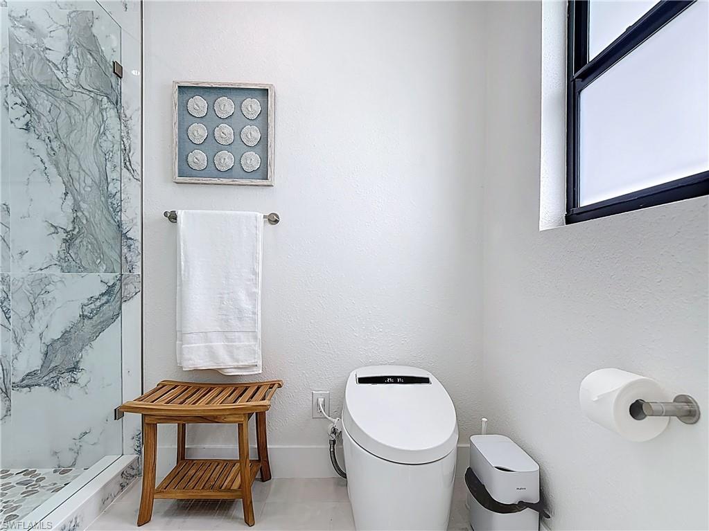 Full bathroom with a walk in shower and toilet
