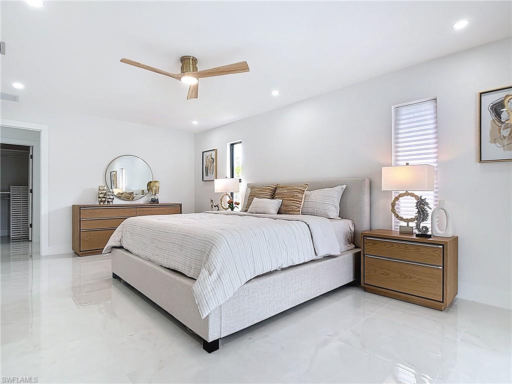 Bedroom with light marble finish floors, recessed lighting, ceiling fan, and baseboards
