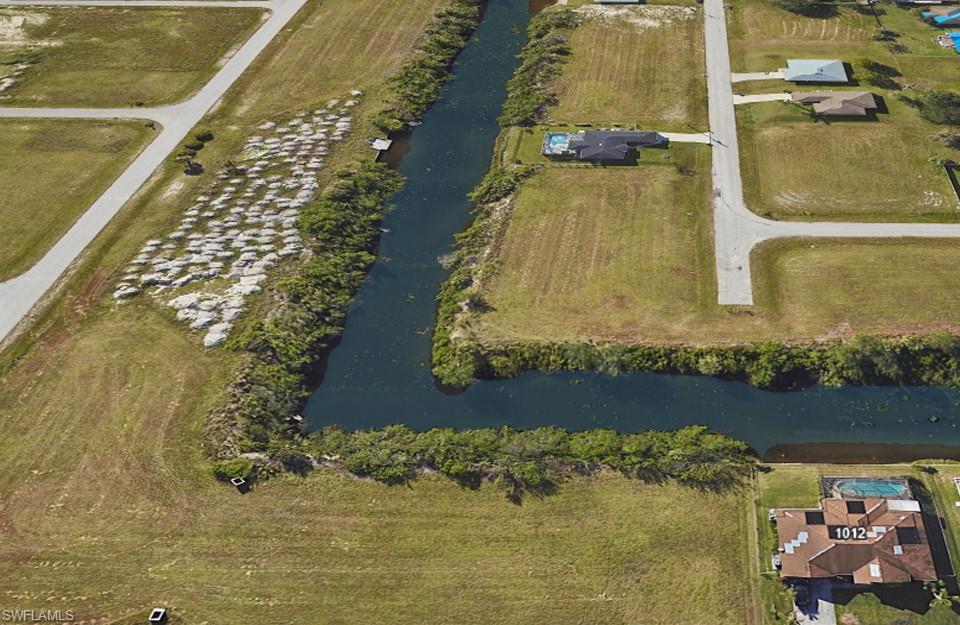 Aerial view of property's location with a large body of water
