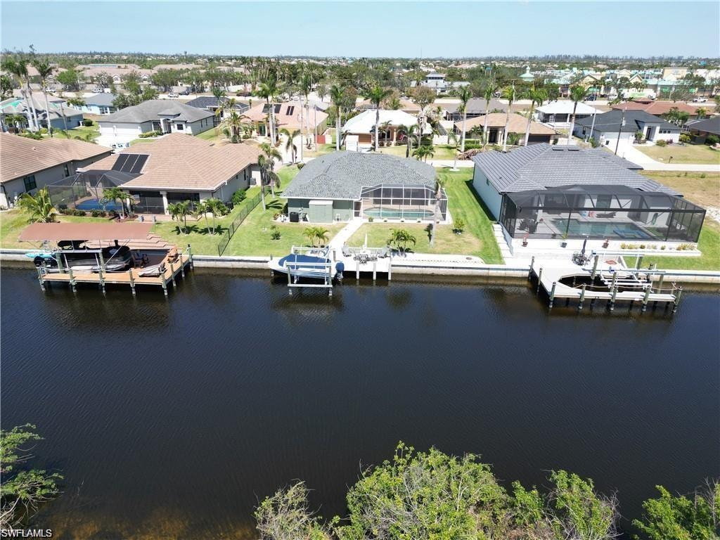 Aerial perspective of suburban area featuring a nearby body of water