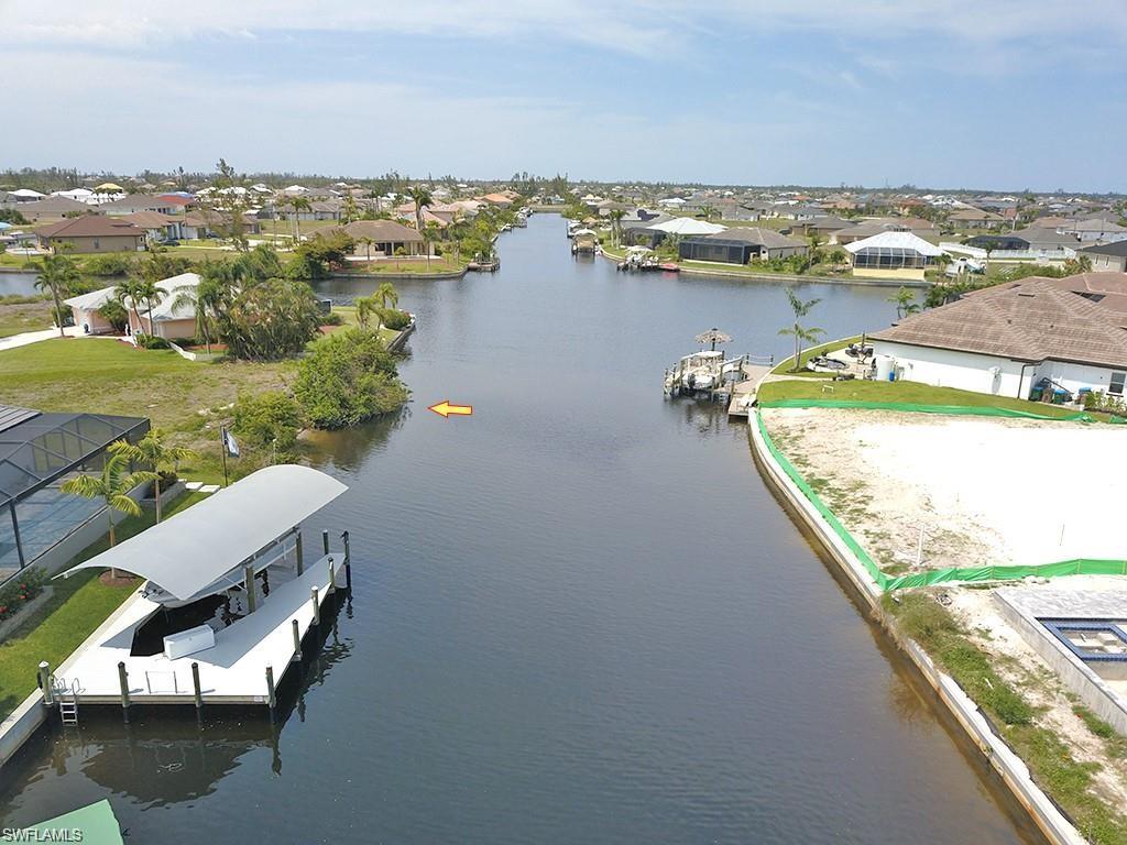 Aerial perspective of suburban area featuring a nearby body of water