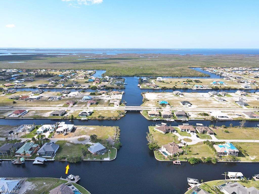 Aerial view of residential area featuring a nearby body of water