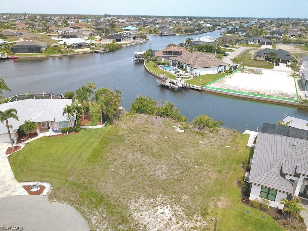 Aerial view of residential area featuring a nearby body of water