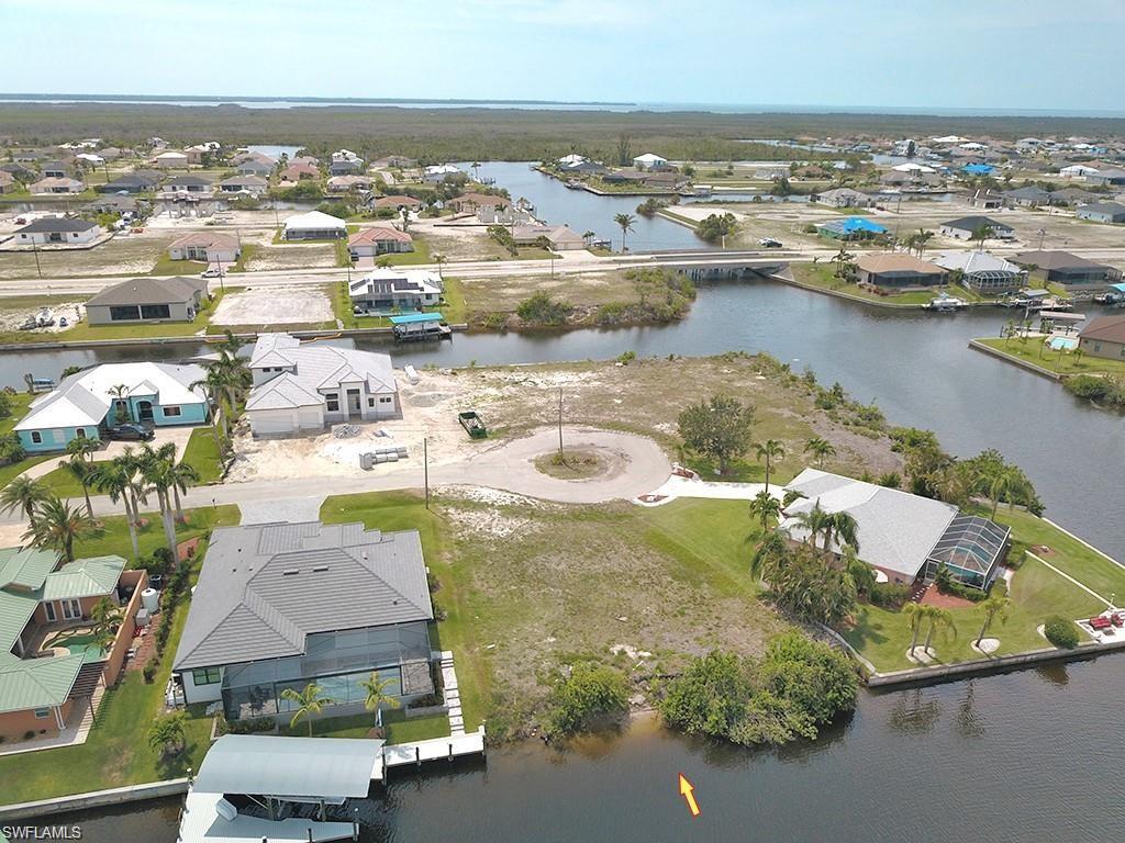 Aerial perspective of suburban area featuring a nearby body of water