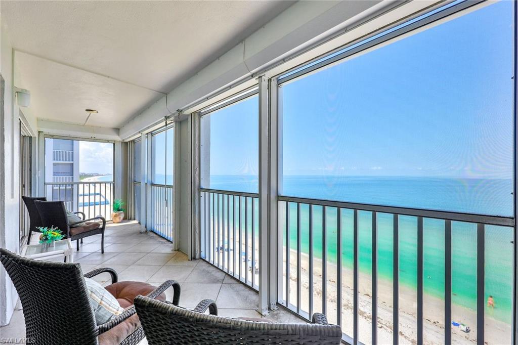 Sunroom / solarium with a view of the beach and a water view