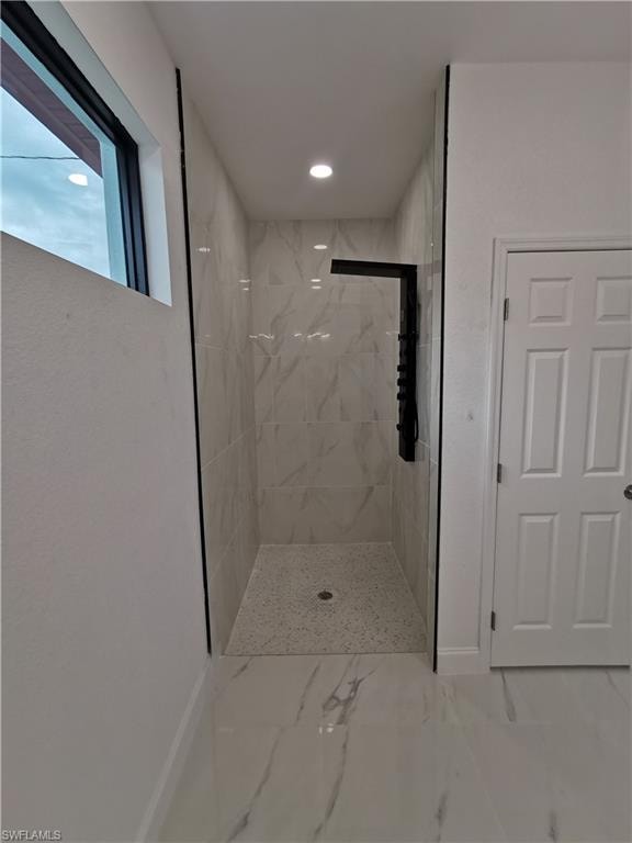 Full bathroom with a marble finish shower, marble finish floors, and recessed lighting