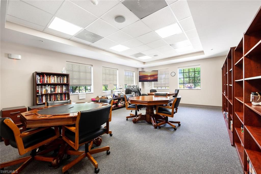 Home office featuring a raised ceiling and carpet floors