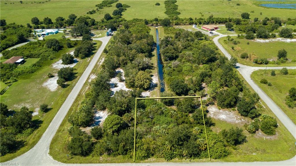 Aerial view of sparsely populated area featuring property parcel outlined
