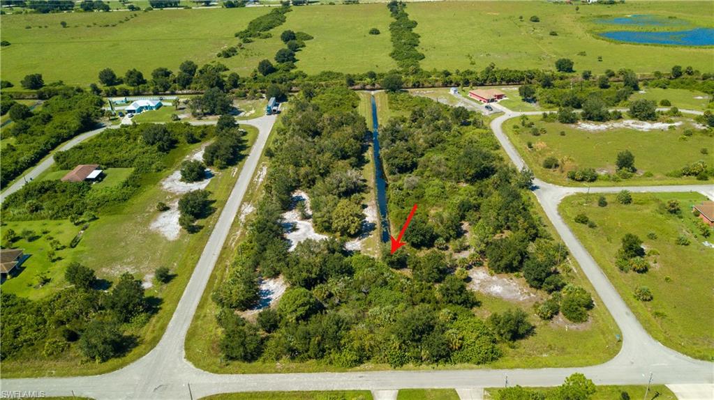 Aerial view of property and surrounding area featuring rural landscape