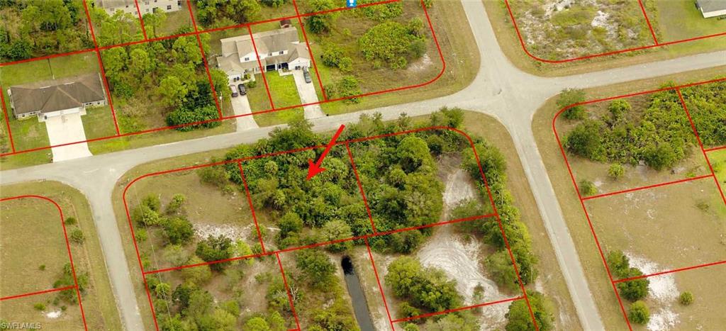 Aerial view of property and surrounding area with property boundaries highlighted