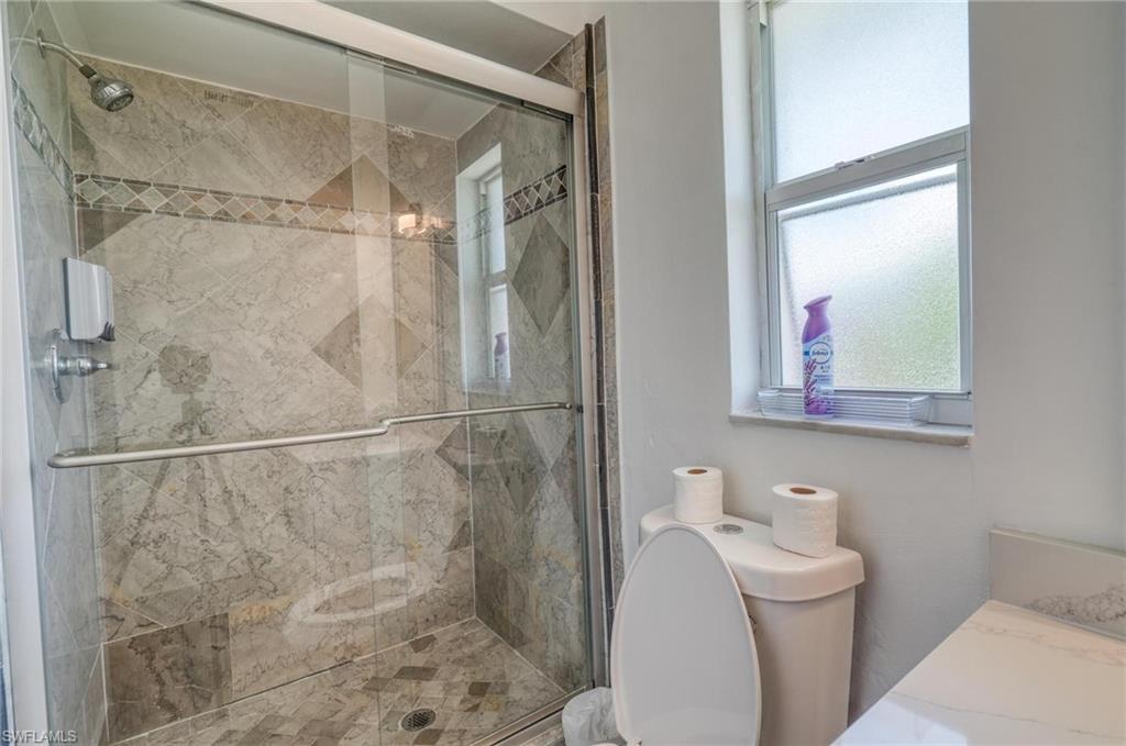 Bathroom with toilet and a stall shower