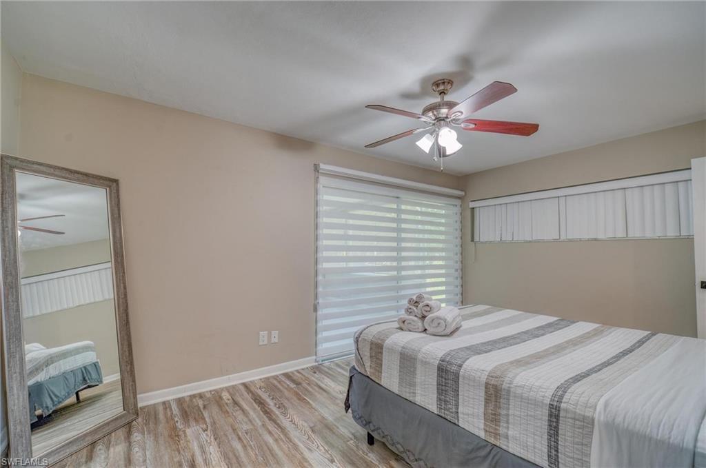 Bedroom featuring light wood-style flooring, baseboards, and ceiling fan