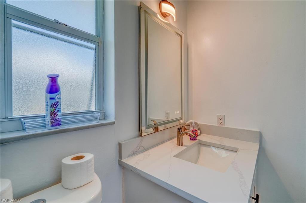 Half bathroom with vanity and toilet