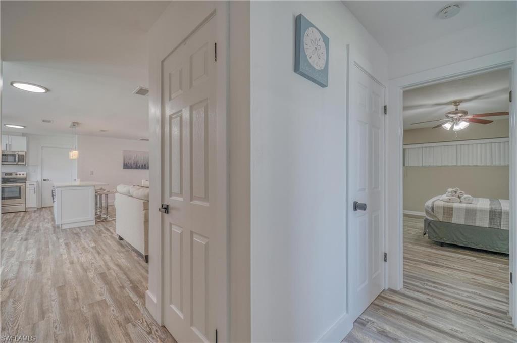 Corridor featuring light wood finished floors