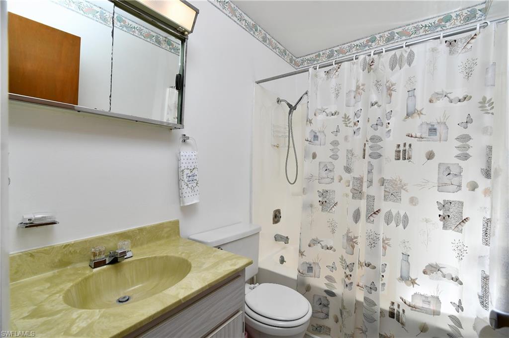 Full bathroom with shower / tub combo, toilet, and vanity
