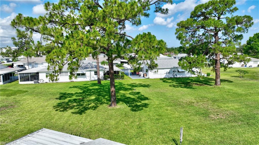 View of green lawn with a residential view