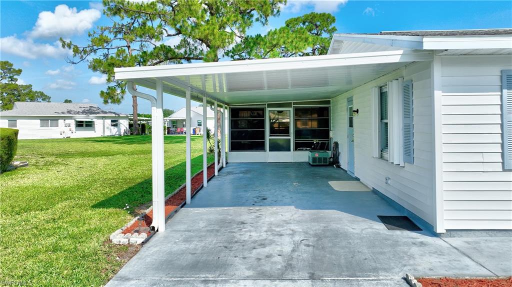 View of patio / terrace with a carport and concrete driveway