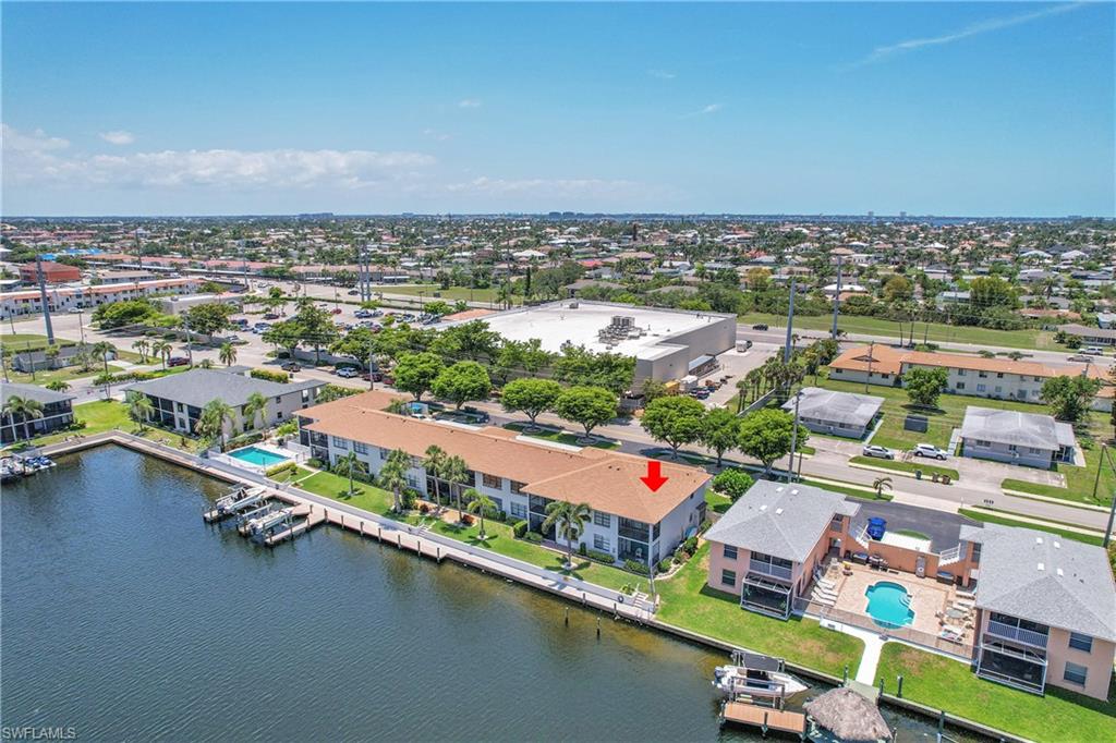 Drone / aerial view of a pool and a large body of water