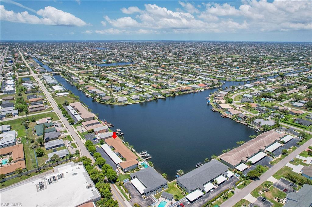 Aerial overview of property's location featuring nearby suburban area and a large body of water