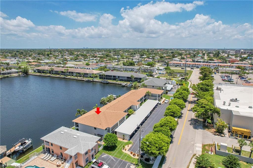 Aerial view of residential area featuring a nearby body of water