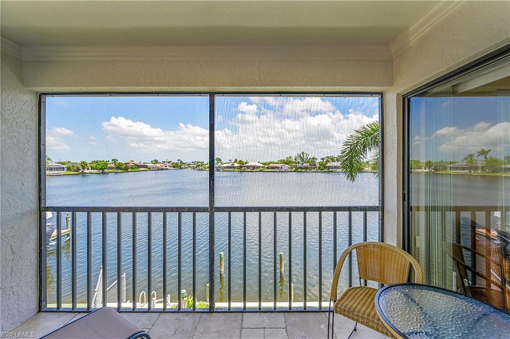 Sunroom featuring a water view