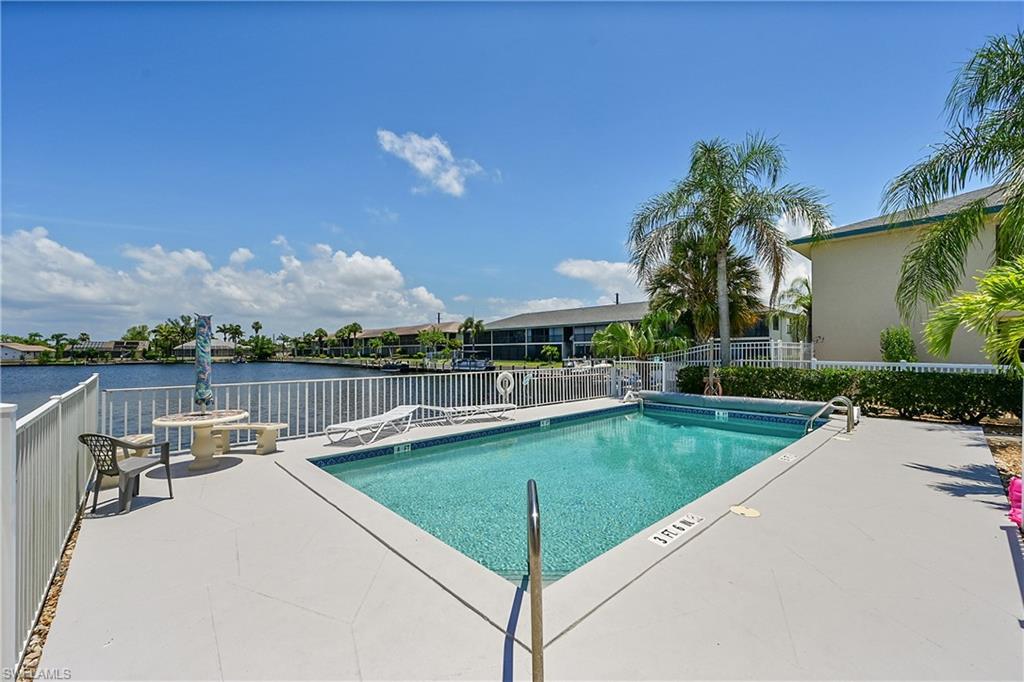 Community pool with a patio and a water view